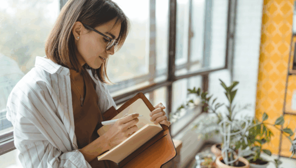 Woman making daily decisions and writing them down.